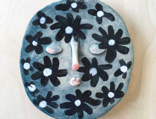 Ceramic face with flower motif