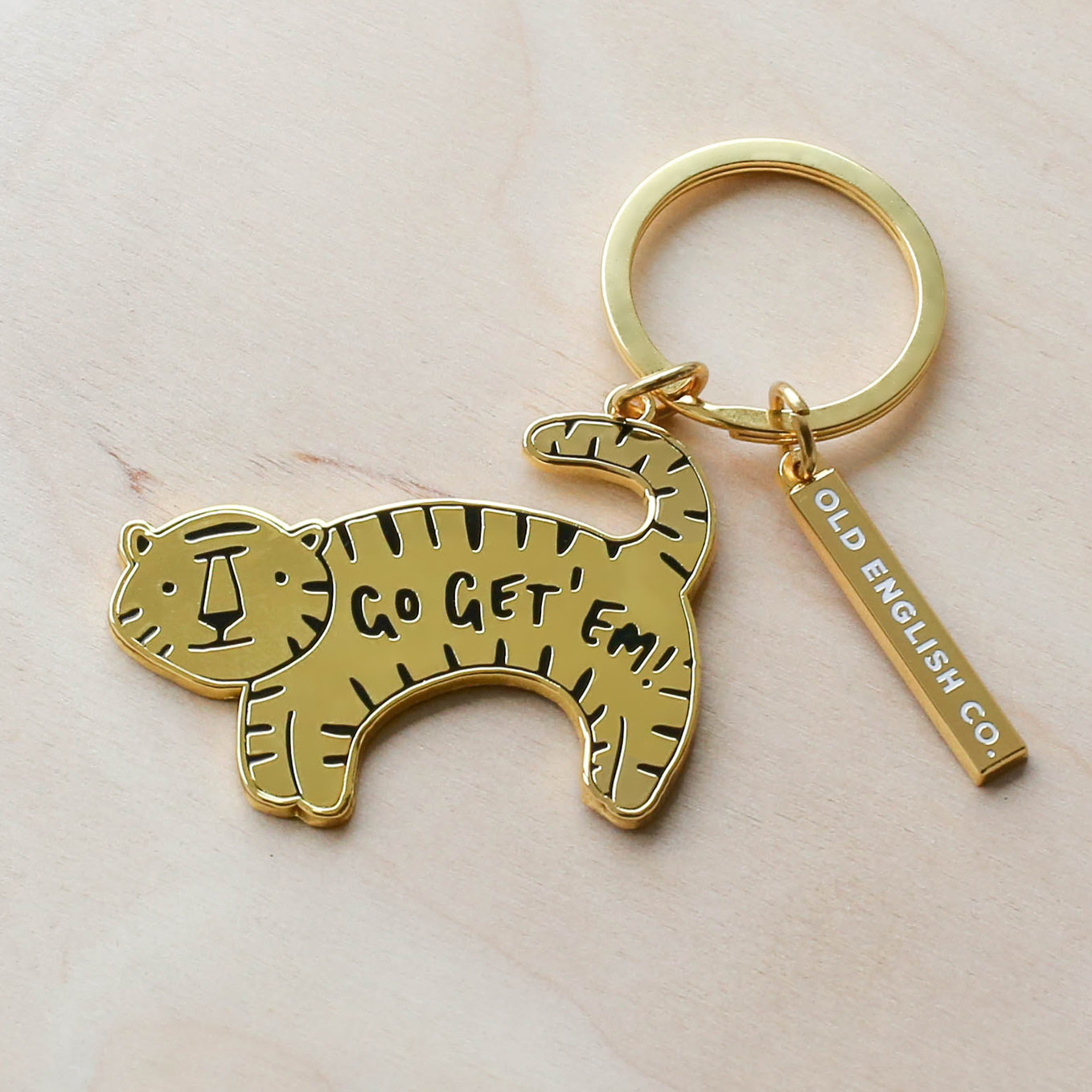 Golden tiger keychain that says "Go Get 'Em"