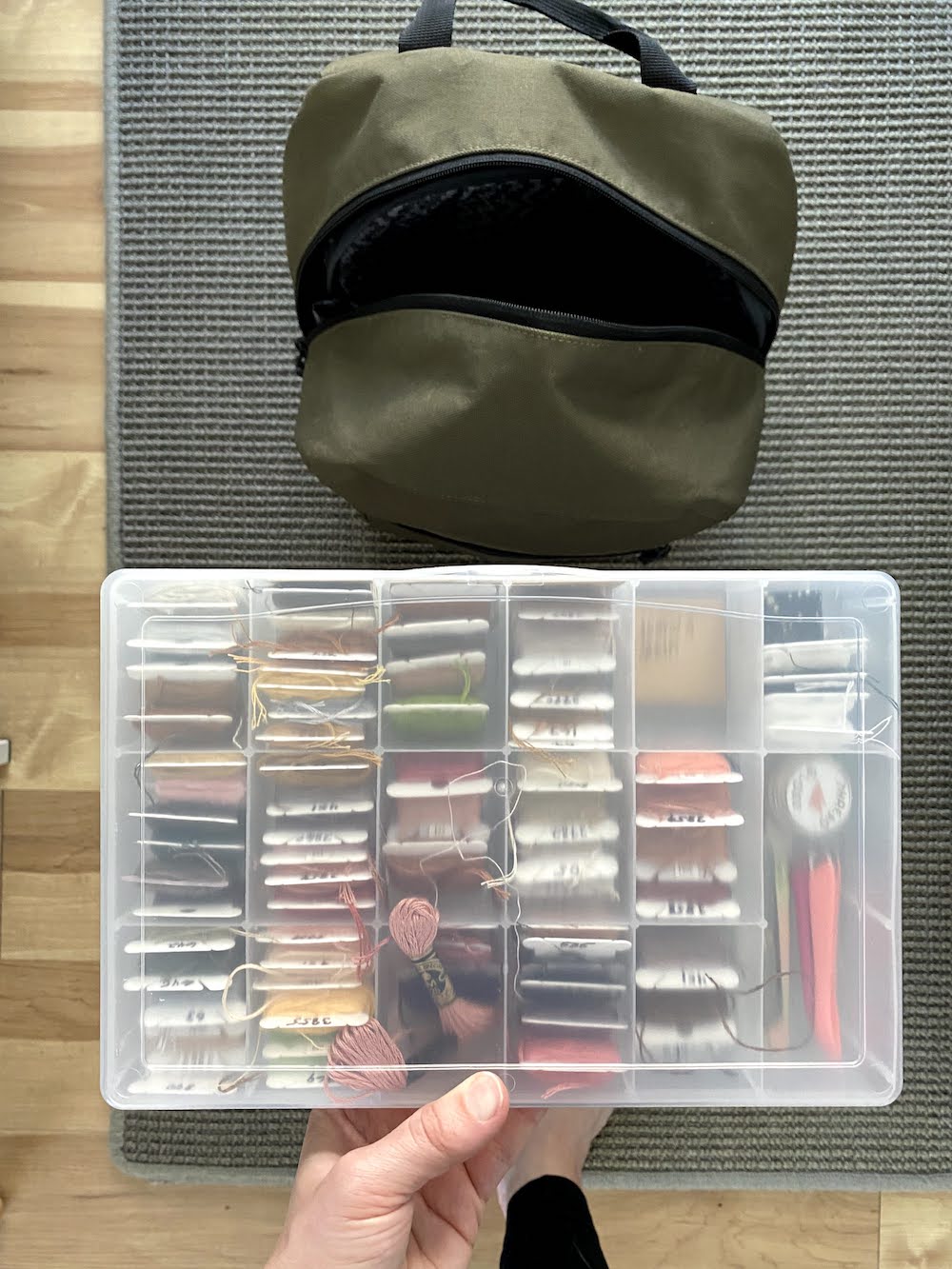 Traveling with embroidery including a storage box to go in backpack