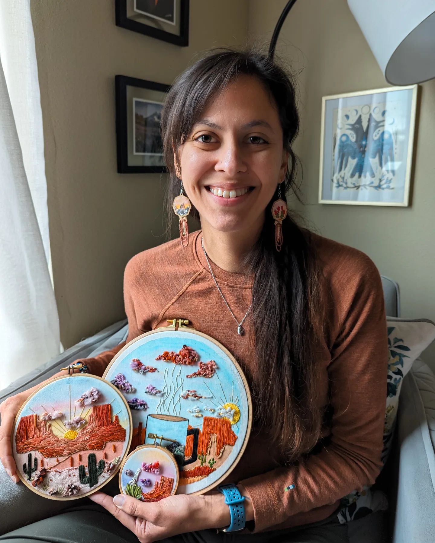 Shannon Moser posing with her embroidery art