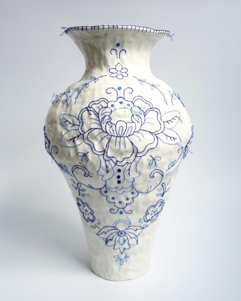 Embroidery on ceramic vase by Caroline Harrius