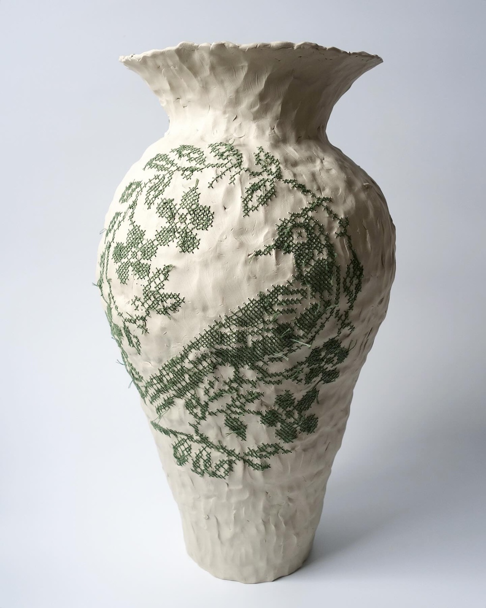 Embroidery on ceramic vase by Caroline Harrius