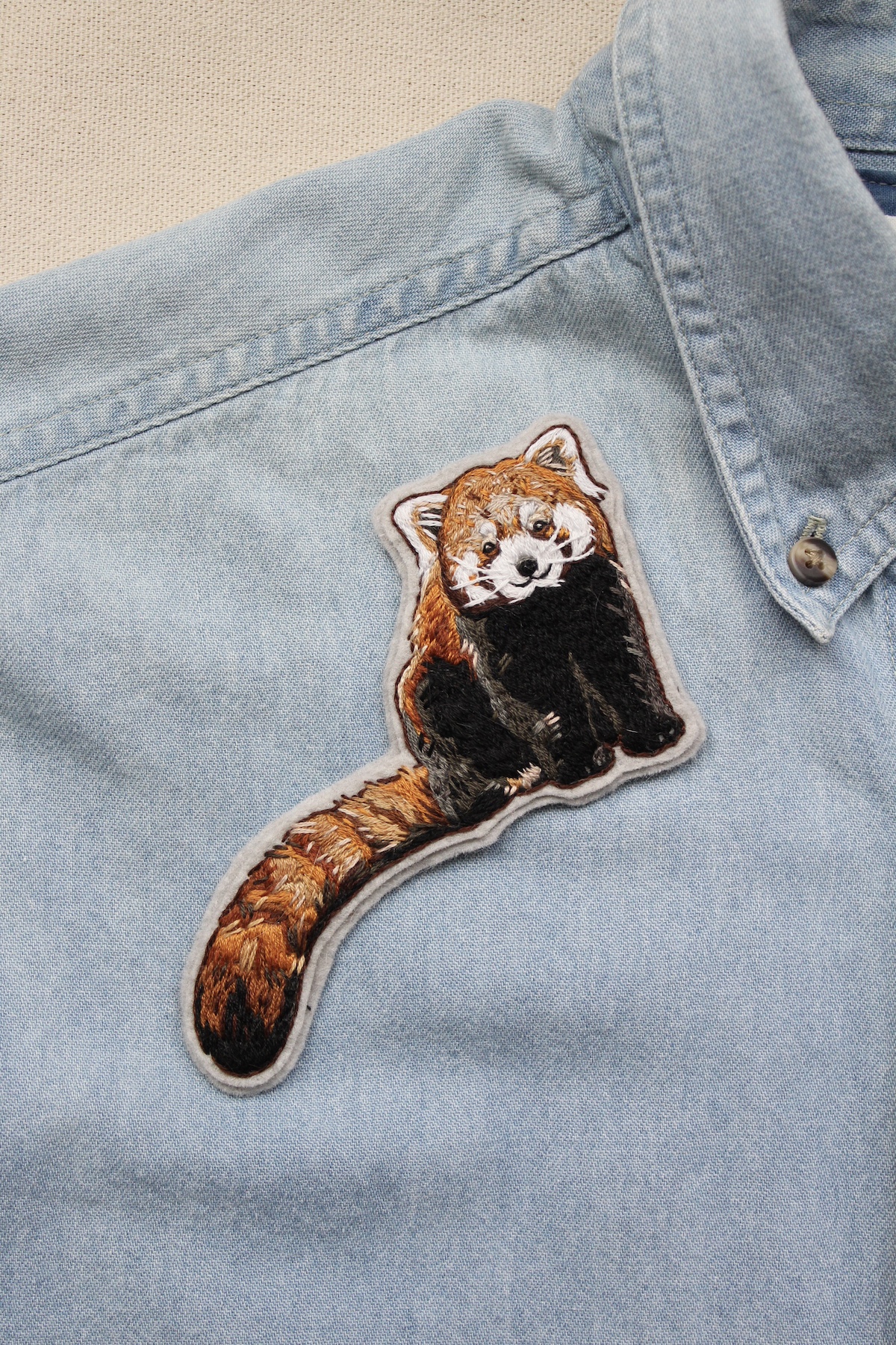 DIY embroidered red panda patch on a shirt 